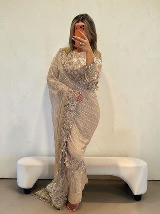 Emaara Luxe Arielle Saree in beige with intricate embroidery and long sleeves, worn by a woman in a mirror selfie.